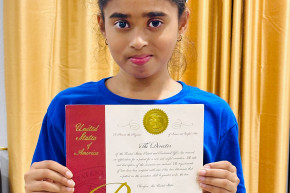 Young inventor Vennela Attili with her patent for the Happy Sleep doll.